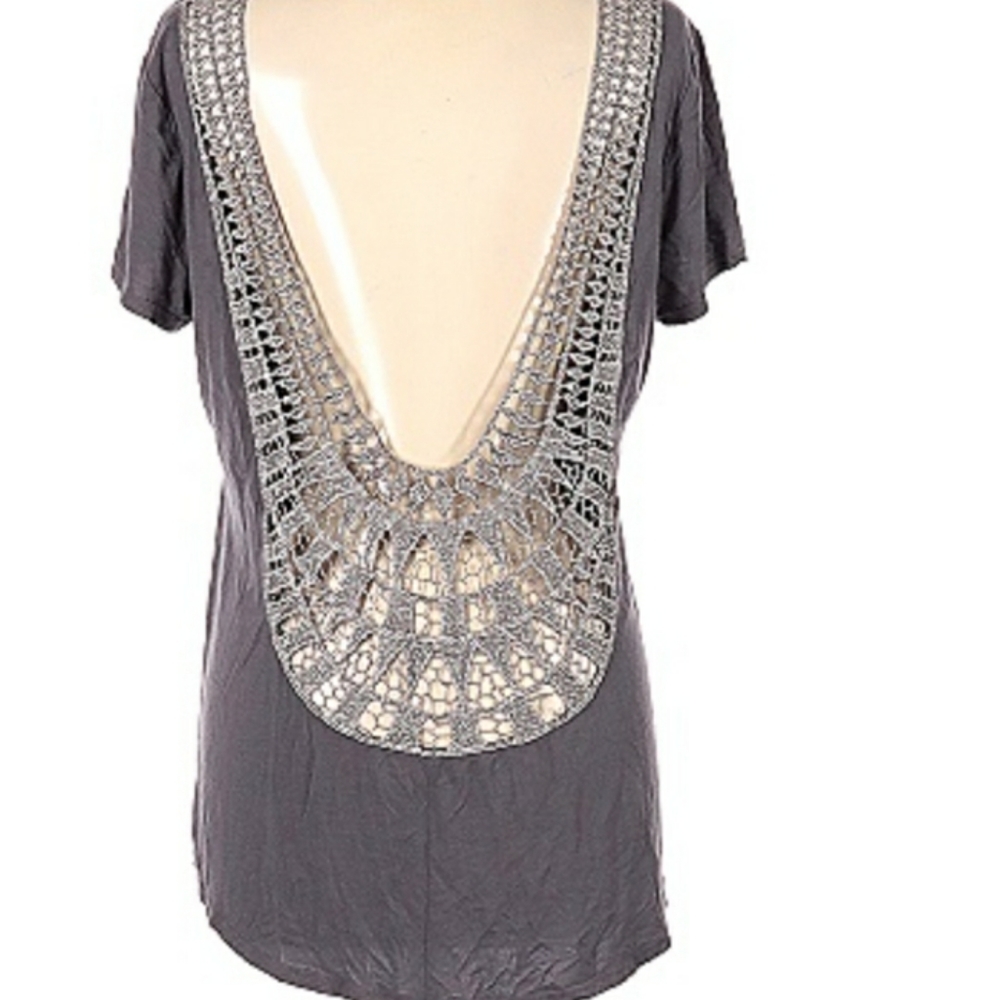 Top with low open back with embroidery  trim.